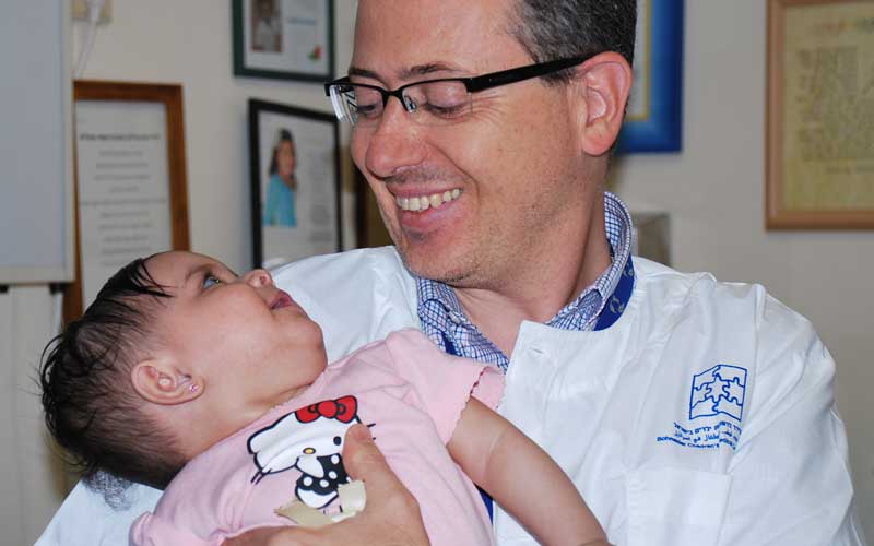 ד"ר אורי אלבז והתינוקת. צילום באדיבות מרכז שניידר לרפואת ילדים